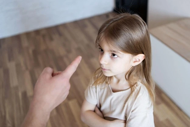 Child being scolded by an adult
